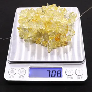 Detail shot of natural yellow citrine irregular stone beads on a scale weighing 70.8 grams
