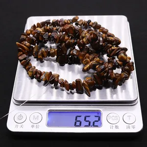 Tiger eye gravel beads on digital scale showing a weight of 65.2g for DIY jewelry making