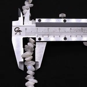 Detail showing 8-10mm irregular white moonstone chips measurement on a black background