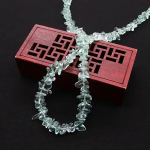 Irregular natural green crystal stone beads for DIY jewelry making on wooden box
