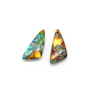 Macro view of two triangle synthetic emperor stone pendants with colorful mineral textures