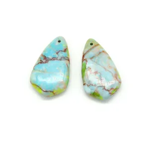 Macro shot of polished teardrop turquoise pendants with intricate mineral vein textures