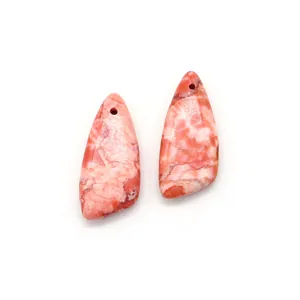 Close-up of teardrop natural stone pendants with pink and orange marble texture for DIY