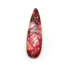 Macro detail of teardrop natural stone pendant with red and gold sand marble texture