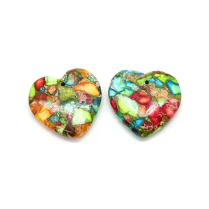 Close-up of colorful heart-shaped stone pendants with pre-drilled holes for DIY jewelry