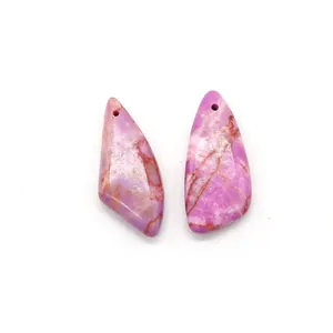 Close-up of dual pink purple triangular natural stone pendants with unique marbled texture