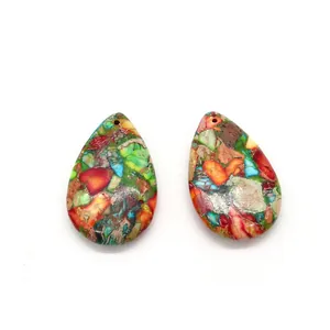 Macro shot of two teardrop-shaped multicolor imperial jasper stone pendants with top-drilled holes