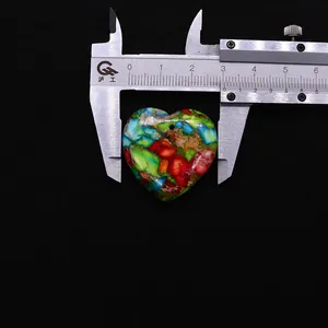 Detailed view of heart-shaped multi-color stone pendant with 26mm width measurement