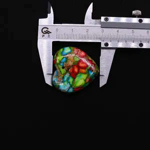 Macro shot showing the 2.6cm width measurement of a heart-shaped multicolor stone pendant