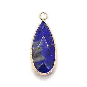 Macro shot of faceted water-drop Lapis Lazuli pendant with elegant gold plated metal edging