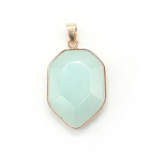 Detailed view of shield-shaped faceted light green crystal pendant with gold plating