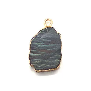 Close-up of irregular tiger eye stone pendant with elegant gold plated metal edging