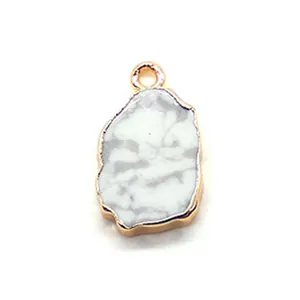 Macro view of natural white marble stone pendant with irregular gold plated edges