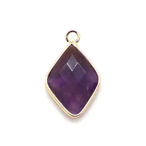 Macro view of faceted purple amethyst rhombus pendant with gold bezel setting