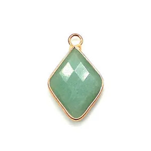 Macro view of faceted natural stone pendant with gold electroplated metal rim for DIY