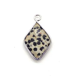 Macro shot of rhombus faceted natural spotted stone pendant with silver metal plating