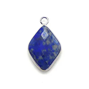 Macro view of faceted diamond-shaped blue lapis lazuli pendant with silver metal plating
