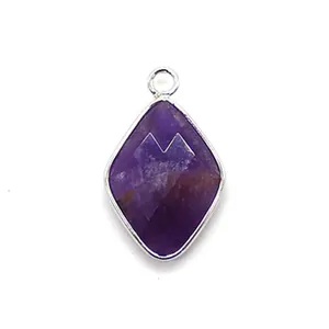 Macro view of faceted rhombus purple gemstone pendant with silver metal border and ring