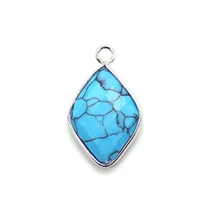 Macro view of a faceted rhombus turquoise pendant with silver-plated metal edges
