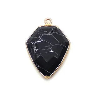 Macro shot of shield-shaped black stone pendant with rose gold plating for DIY jewelry