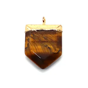 Detailed macro view of sword-shaped natural tiger eye stone pendant with golden hardware