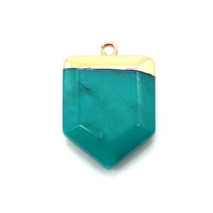 Detail of malachite sword pendant with gold plated metal cap and natural stone texture