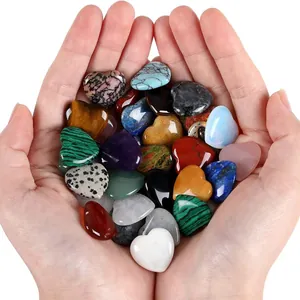 Handheld heart-shaped polished natural stones in various materials like amethyst and tiger eye