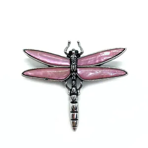 Dragonfly brooch with natural pink shell wings and vintage silver finish on white background