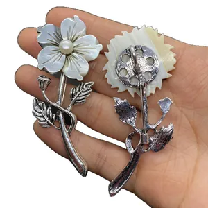 Handcrafted shell flower brooch with silver metal and white pearl center detail