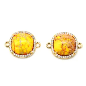 Detail of natural imperial stone connectors with gold plated micro-pave cubic zirconia edges