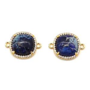 Detail of blue emperor stone connectors with crystal pave border and gold plated finish