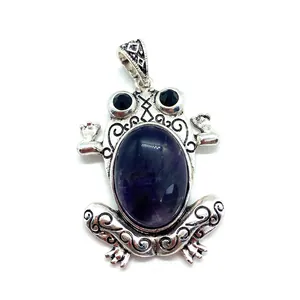 Bohemian silver frog pendant with oval purple gemstone and ornate filigree engraving