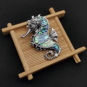 Seahorse brooch pendant featuring natural abalone shell inlay and silver alloy finish
