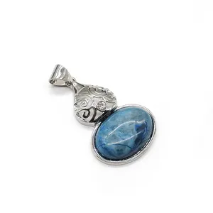 Close-up of oval blue natural stone pendant with intricate silver filigree details