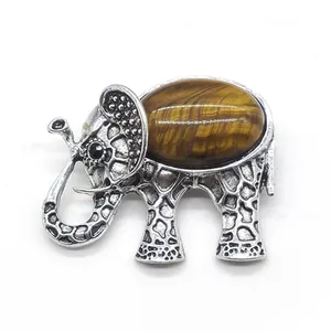 Detail of elephant brooch with tiger eye stone and intricate silver metal engraving