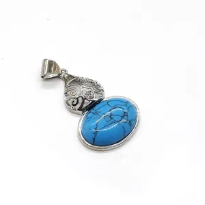 Macro detail of blue turquoise pendant with vintage hollow floral silver-tone base