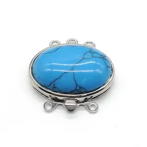 Macro detail of oval turquoise stone inset in a triple-row zinc alloy jewelry clasp