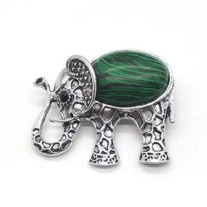 Detail of elephant brooch with green malachite stone and antique silver finish