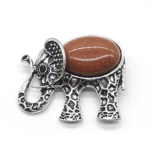Detail of vintage elephant brooch with brown sandstone inlay and antique silver finish