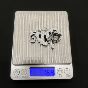 Detailed view showing the 16.4g weight of the seahorse brooch on a digital scale