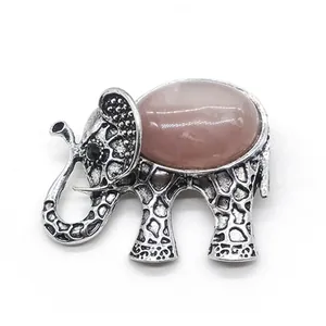 Detail view of elephant brooch with pink gemstone and antique silver-tone textures