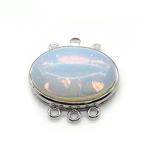 Macro detail of oval opal stone connector with six silver-tone metal rings for DIY jewelry