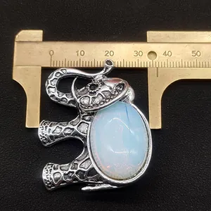 Detailed view of elephant pendant with natural stone and ruler showing 45mm size