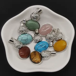 Assorted natural stone gourd pendants with vintage silver filigree caps in a white dish