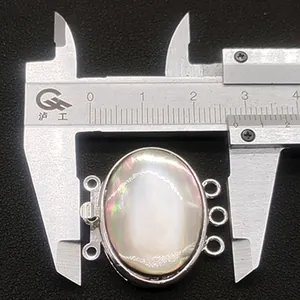 Detailed view of triple-strand shell clasp measured with a caliper, size approx 25mm