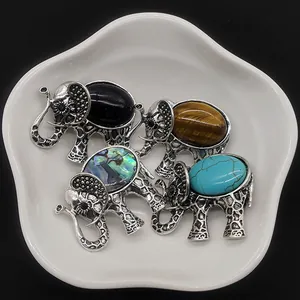 Elephant brooch set with natural stones including tiger eye and abalone shell inlay