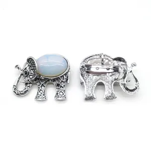 Vintage elephant brooch with natural stone inlay and silver-toned alloy texture