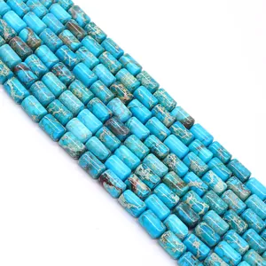 Macro view of polished turquoise blue imperial jasper cylinder beads for DIY jewelry