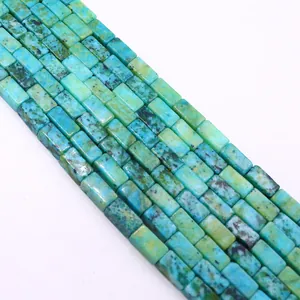 Detailed close-up of rectangular natural turquoise beads with unique dark brown textures