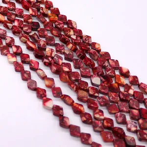 Dettaglio di perle in pietra naturale rossa a forma di rombo con trama marmorea per gioielli